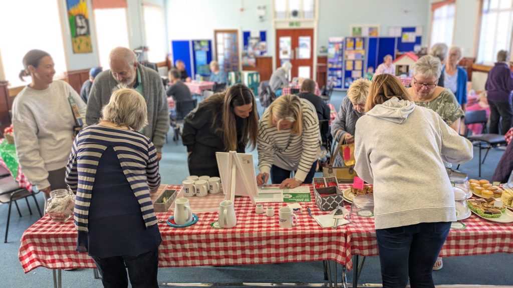 Room filled with people enjoying the Macmillan coffee morning
